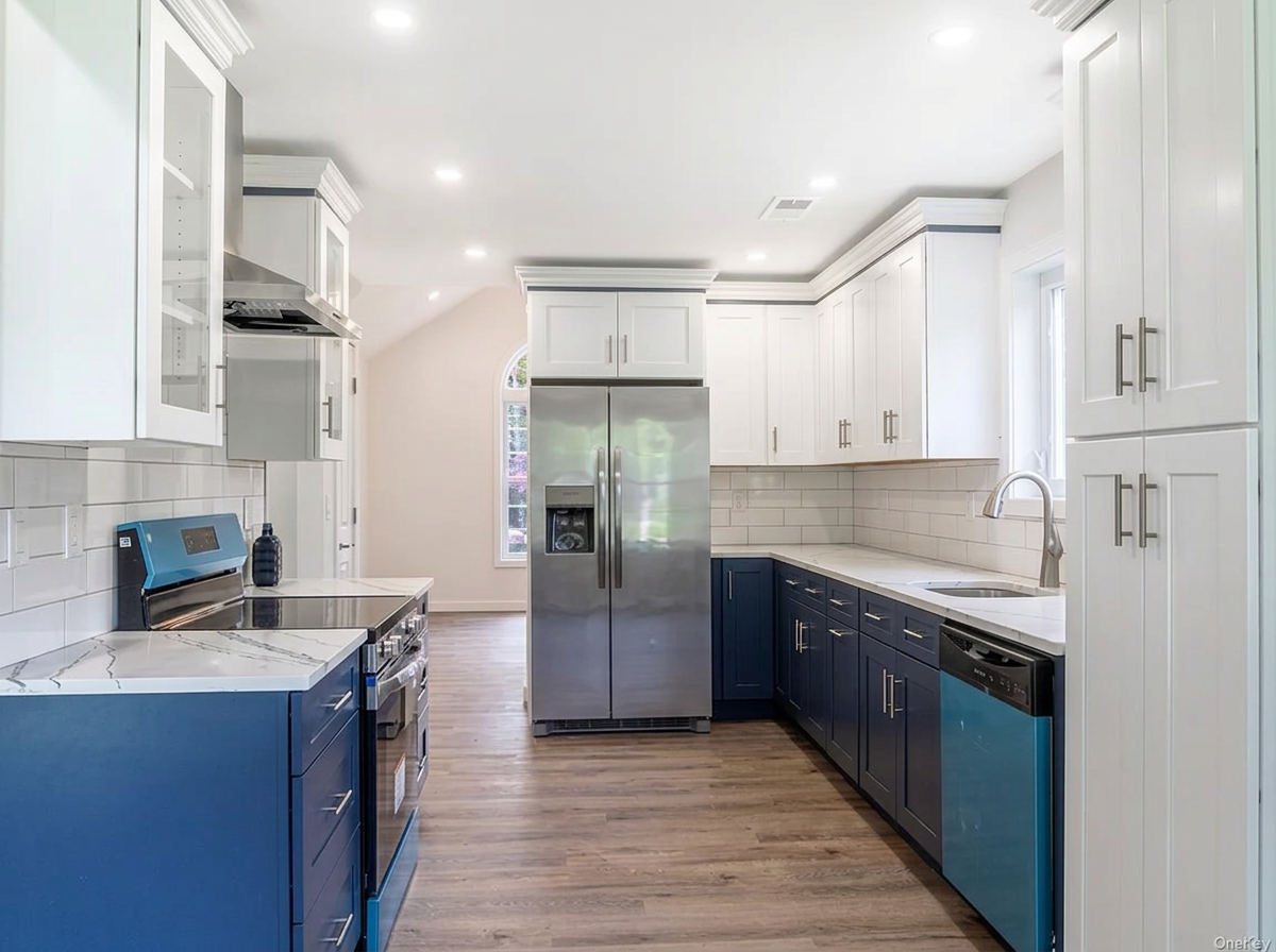Modern kosher kitchen with white and navy cabinetry