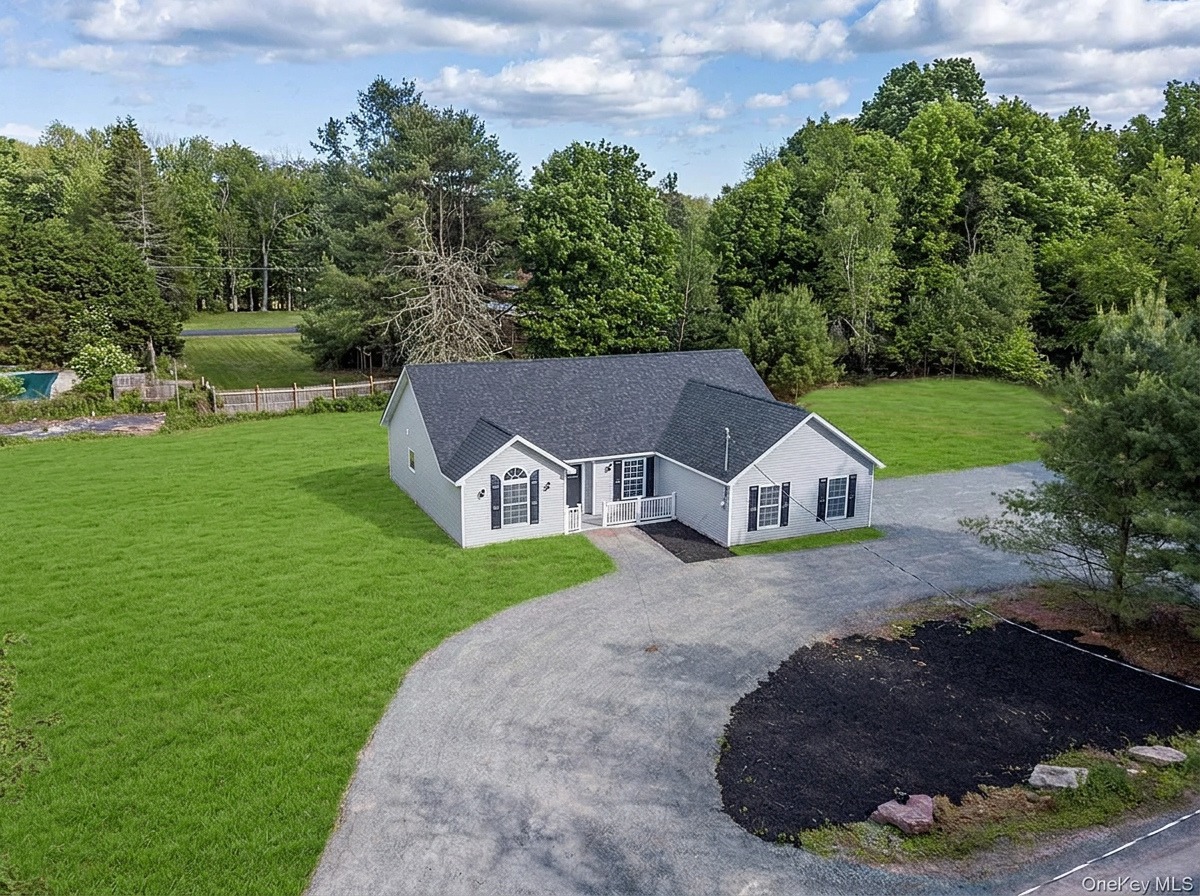 Aerial view of the home on its private acre